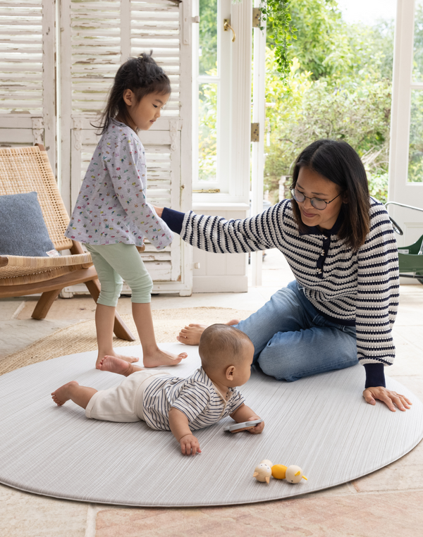 Mom and children enjoying the Baby play mats the whole family will love The Tali has a stylish ombre design with tan and beige tones