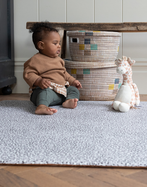 Child enjoys playtime on the non toxic play mat by totter and tumble with thick and safe design