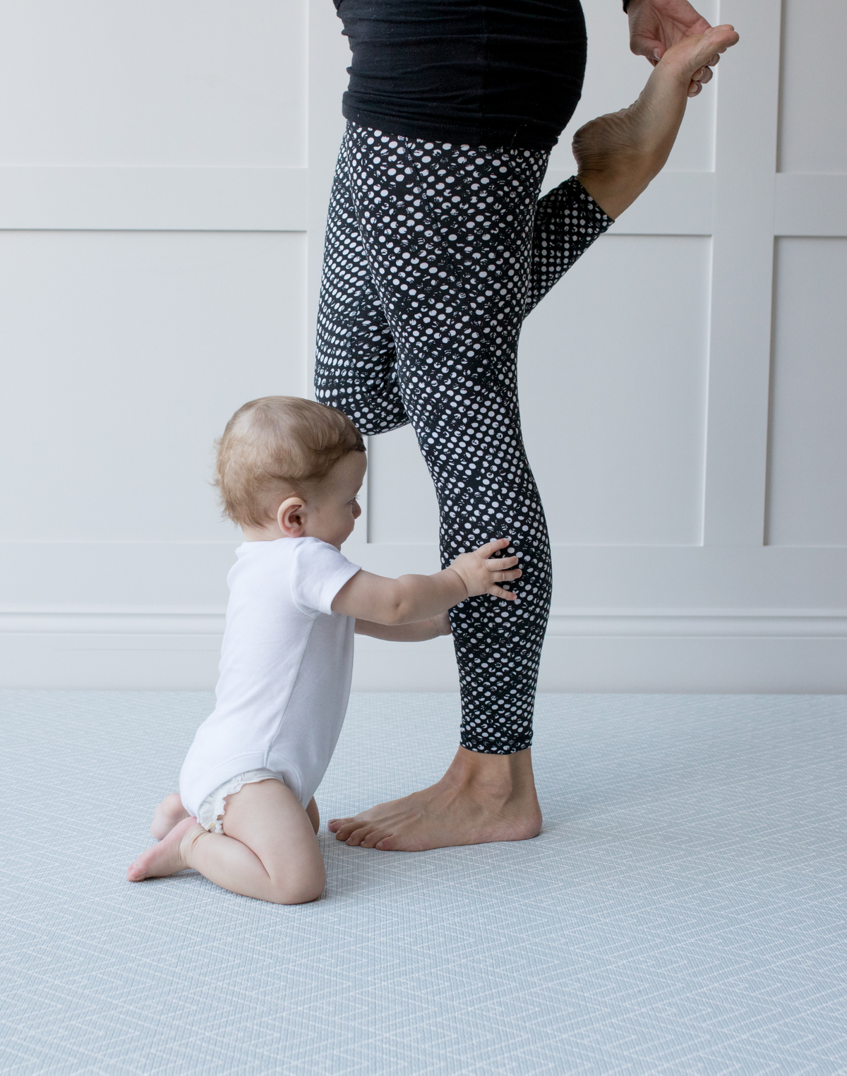 Baby and mom enjoy floor time together on the padded foam floor mat