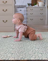 Baby in crawling stance on Morris & Co. Willow Boughs play mat by Totter and Tumble non toxic play mat perfect for babies