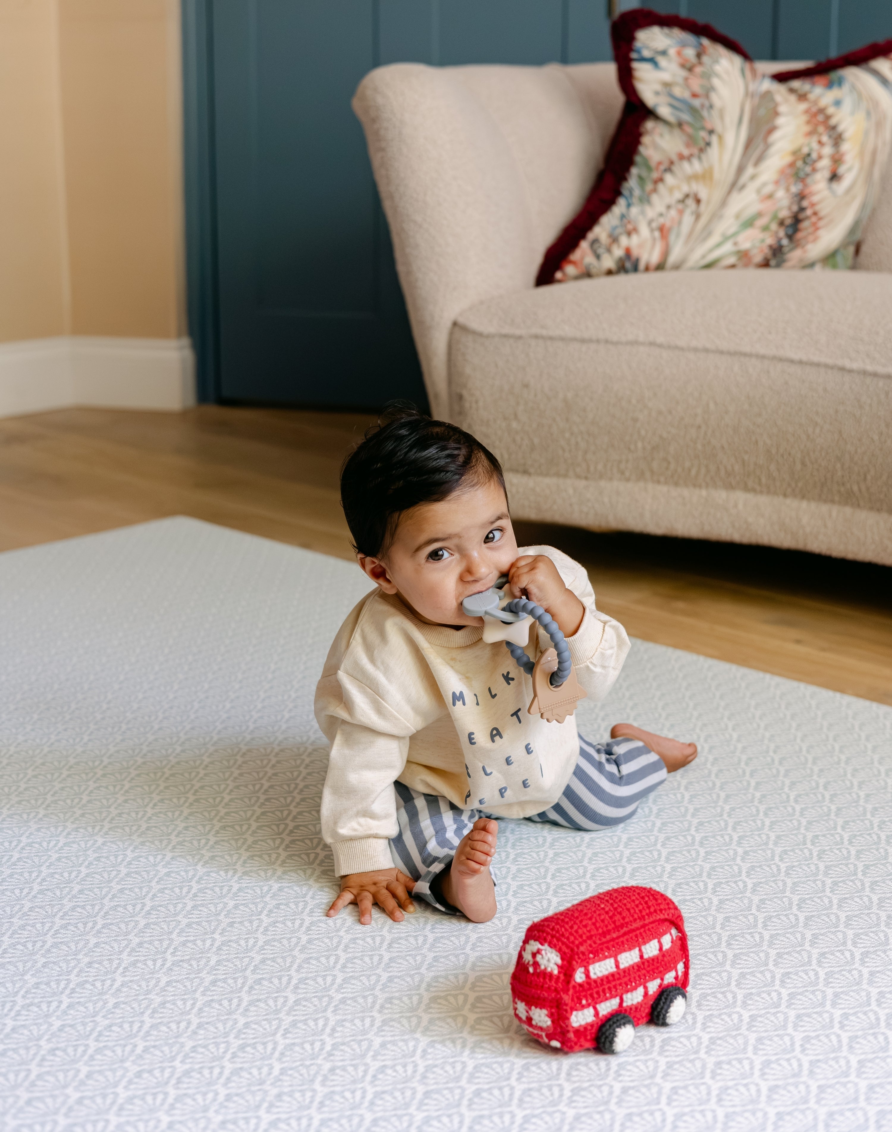 A baby sat playing on the beachcomber play mat from totter and tumble | SKU: 26 BEACH/GATHER XL, 26 BEACH/GATHER STD, 26 BEACH/GATHER COMP