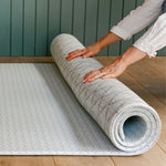 A person unrolling The Beachcomber play mat showing it's reversible design | SKU: 26 BEACH/GATHER XL, 26 BEACH/GATHER STD, 26 BEACH/GATHER COMP