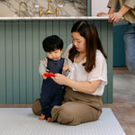 A family sat comfortably on the beachcomber play mat in a kitchen diner | SKU: 26 BEACH/GATHER XL, 26 BEACH/GATHER STD, 26 BEACH/GATHER COMP