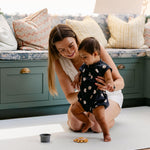 A woman helping a baby take their first steps comfortably and safely on a totter and tumble play mat | SKU: 26 BEACH/GATHER XL, 26 BEACH/GATHER STD, 26 BEACH/GATHER COMP
