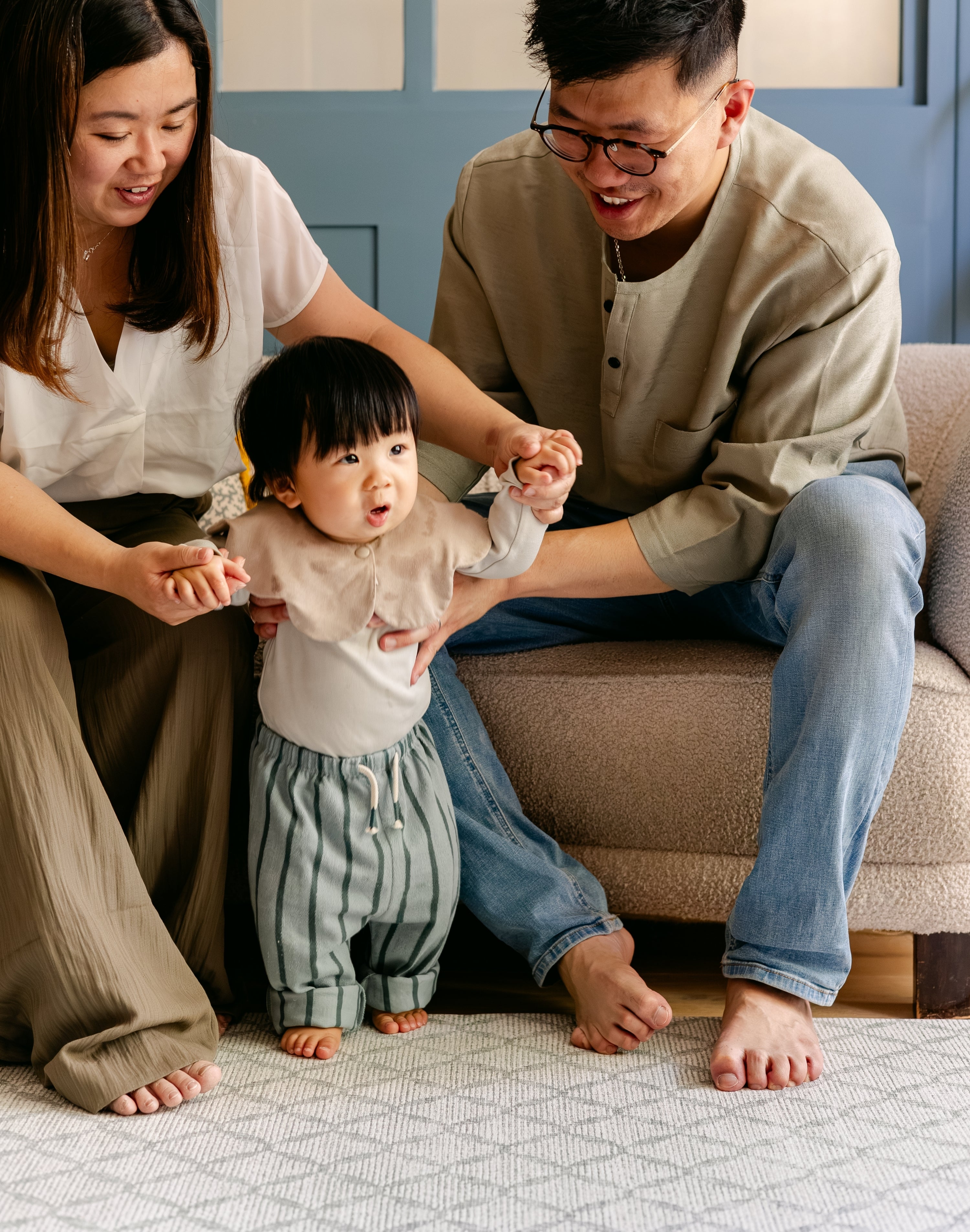 A family helping a baby take steps safely and comfortably on a thick memory foam totter and tumble play mat | SKU: 26 BEACH/GATHER XL, 26 BEACH/GATHER STD, 26 BEACH/GATHER COMP