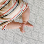  A close up of baby's feet on the gatherer play mat from totter and tumble | SKU: 26 BEACH/GATHER XL, 26 BEACH/GATHER STD, 26 BEACH/GATHER COMP