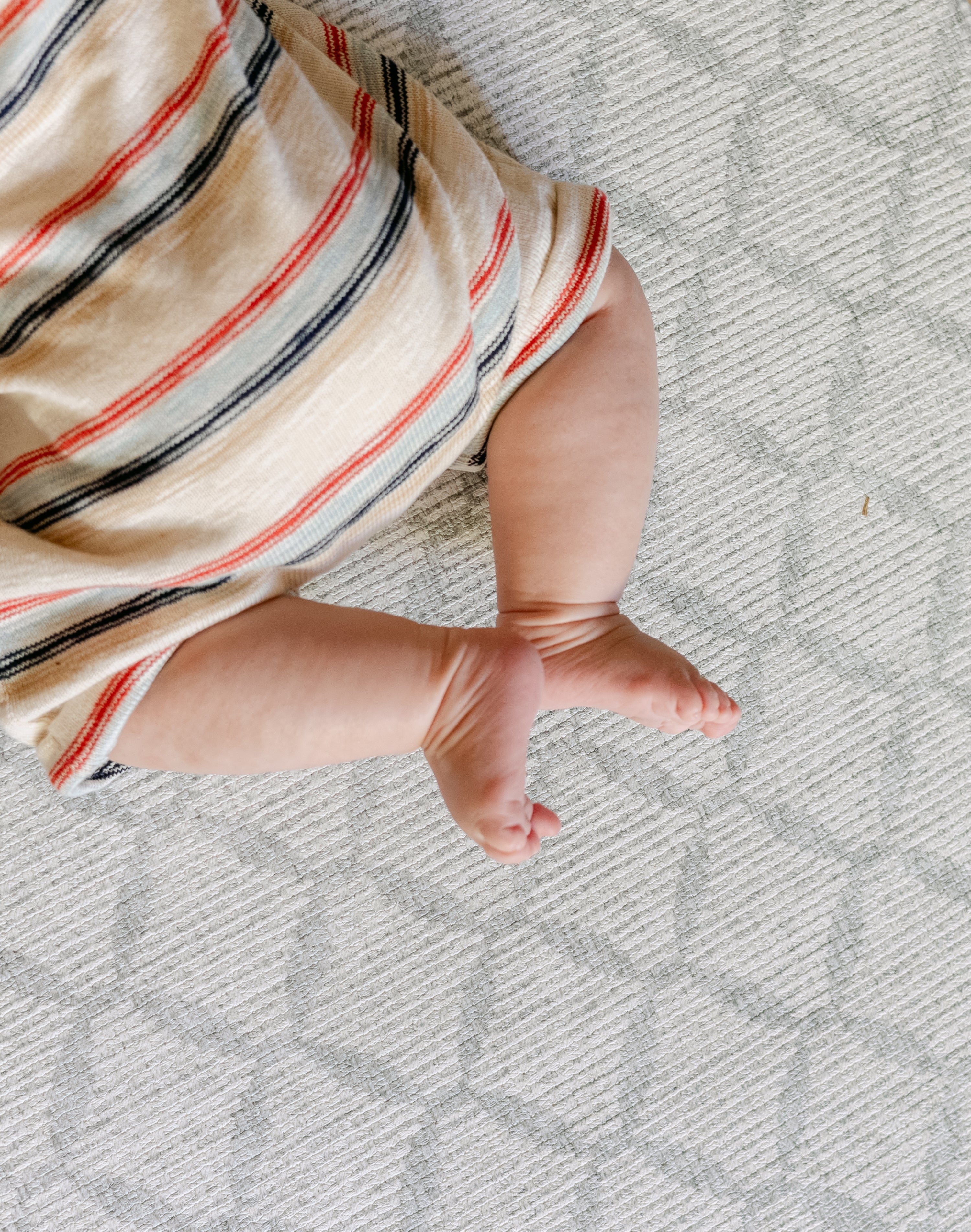 A close up of baby's feet on the gatherer play mat from totter and tumble | SKU: 26 BEACH/GATHER XL, 26 BEACH/GATHER STD, 26 BEACH/GATHER COMP
