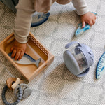 A baby playing with toys on a coastal inspired design play mat, rug-like, soft and safe | SKU: 26 BEACH/GATHER XL, 26 BEACH/GATHER STD, 26 BEACH/GATHER COMP