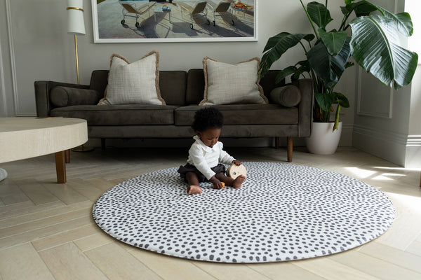 The Scout + The Wanderer in the round shape from Totter and Tumble. Iconic spotty print great for sensory development for babies and versatile round size is great to suit many home interior spaces. Stylish playmats for the whole family