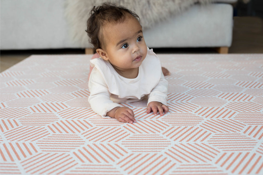 baby happily doing tummy time on Totter and tumble's soft padded play mat The Dreamer. With Coral hexagons this one tile playmat is stylish and functional.
