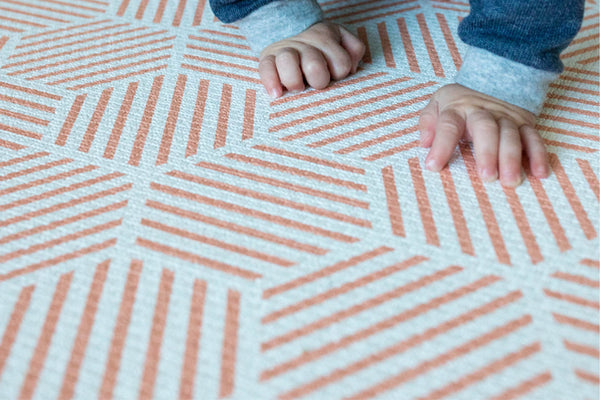 close up of coral hexagon padded memory foam one piece Totter and Tumble play mat